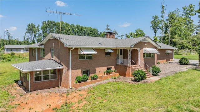 8521 US Highway 64 E, Ramseur, NC 27316 - ranch-style home with a front yard, a chimney, and brick siding