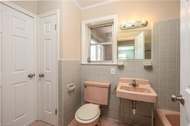 8521 US Highway 64 E, Ramseur, NC 27316 - full bath with a sink, tile walls, toilet, ornamental molding, and a wainscoted wall
