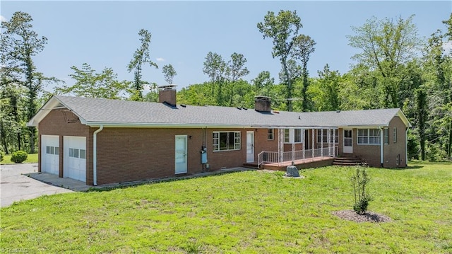 8521 US Highway 64 E, Ramseur, NC 27316 - single story home featuring a chimney, brick siding, a garage, a front lawn, and concrete driveway