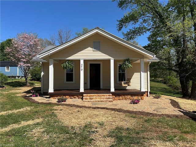 bungalow-style home featuring a porch and a front yard