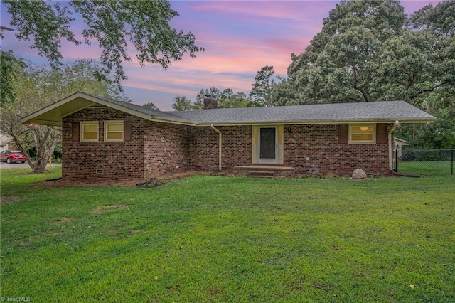 ranch-style home featuring a yard