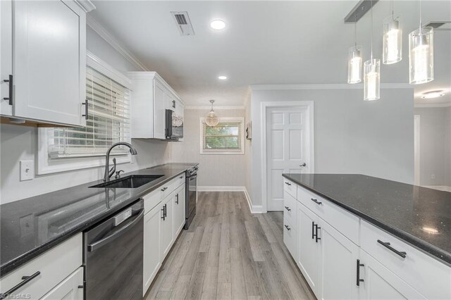 washroom featuring cabinets, light hardwood / wood-style flooring, washer and clothes dryer, and crown molding