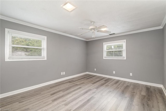 spare room featuring light hardwood / wood-style floors, ornamental molding, and ceiling fan