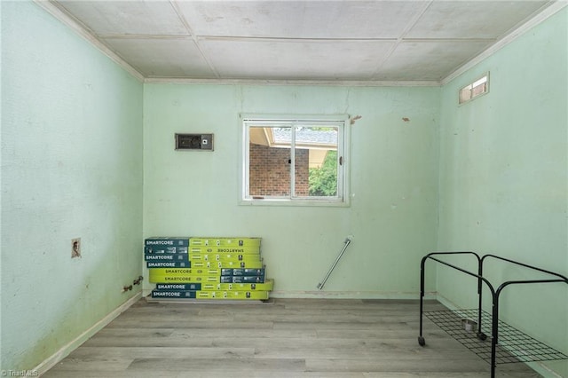 interior space featuring ornamental molding and light hardwood / wood-style floors