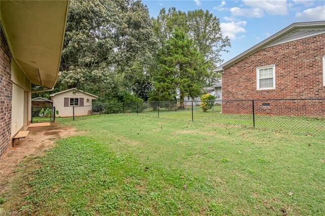 ranch-style home with a front yard, central AC unit, and a carport