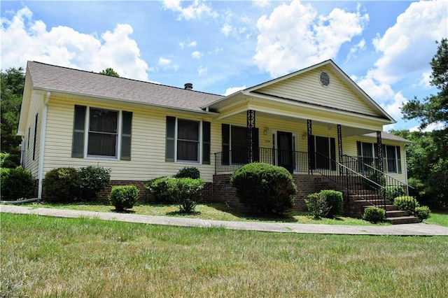 view of front of property with a porch and a front lawn