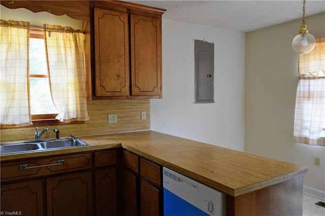 kitchen featuring tasteful backsplash, electric panel, white dishwasher, pendant lighting, and sink