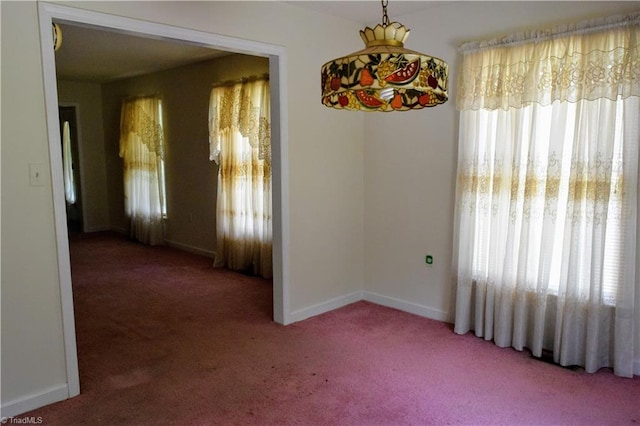 empty room featuring dark colored carpet