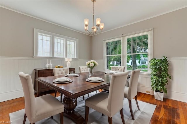 dining space featuring a chandelier, dark hardwood / wood-style floors, and crown molding