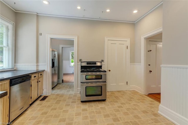 kitchen with ornamental molding, appliances with stainless steel finishes, a healthy amount of sunlight, and light brown cabinetry