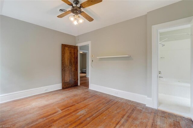 unfurnished bedroom featuring ceiling fan and hardwood / wood-style floors