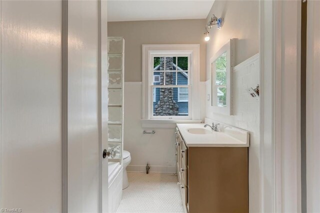 bathroom with tile patterned flooring, vanity, and toilet