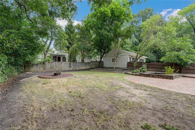 view of yard featuring a patio area and an outdoor fire pit