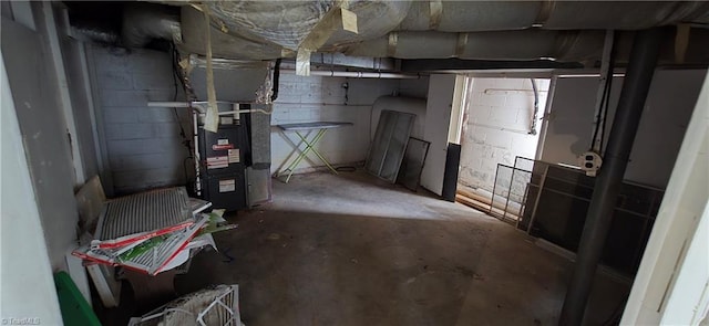 unfinished basement with heating unit and concrete block wall