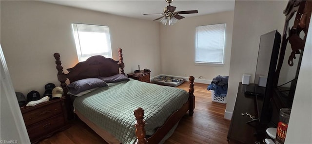 bedroom featuring dark wood finished floors, ceiling fan, and baseboards