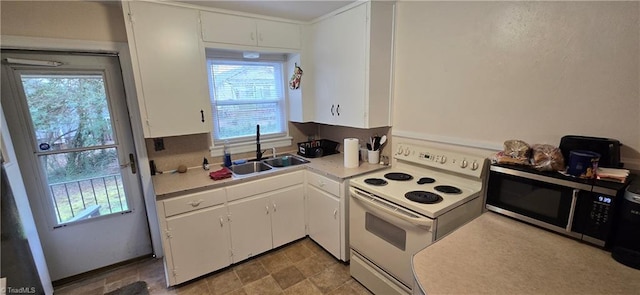 kitchen featuring electric range, white cabinetry, stainless steel microwave, and a sink