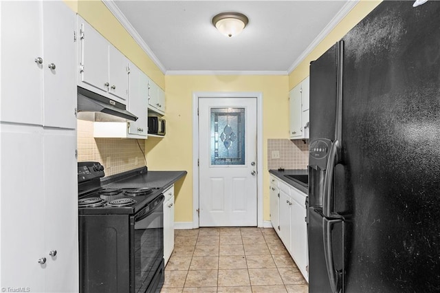 103 E St, Jonesville, NC 28642 - kitchen with black appliances, under cabinet range hood, dark countertops, ornamental molding, and tasteful backsplash