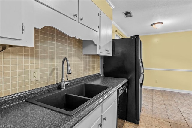 103 E St, Jonesville, NC 28642 - kitchen with dark countertops, crown molding, black appliances, backsplash, and white cabinetry
