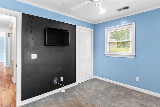 103 E St, Jonesville, NC 28642 - unfurnished bedroom with a closet, crown molding, and ceiling fan