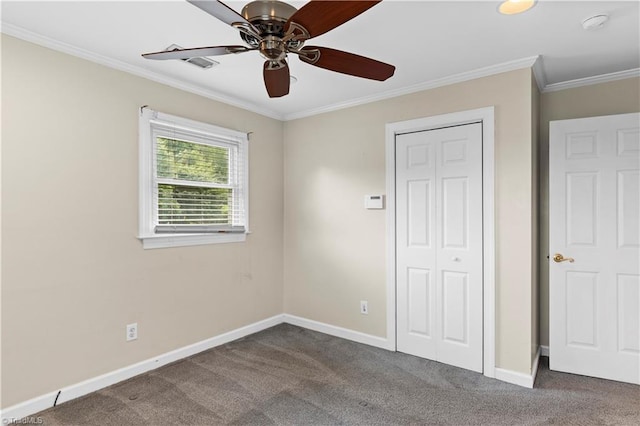 103 E St, Jonesville, NC 28642 - unfurnished bedroom with dark colored carpet, crown molding, a closet, and a ceiling fan