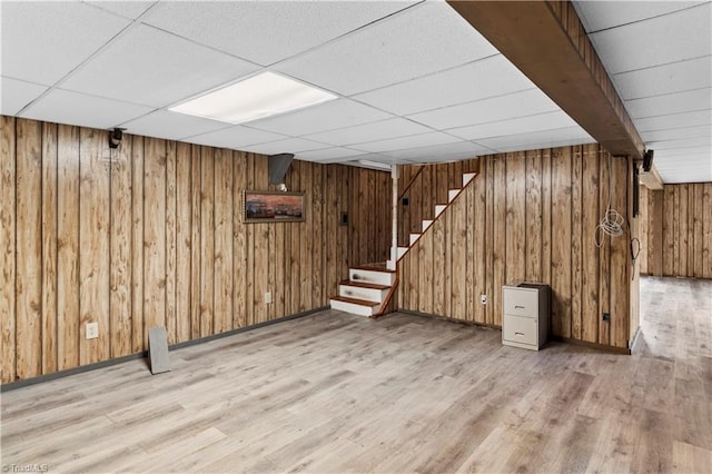 103 E St, Jonesville, NC 28642 - finished basement with wood walls, light wood-type flooring, stairway, and a drop ceiling