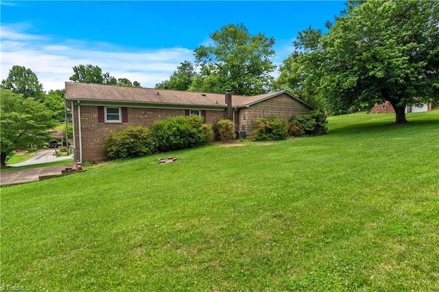103 E St, Jonesville, NC 28642 - back of house with a yard and brick siding