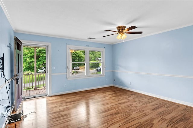 103 E St, Jonesville, NC 28642 - unfurnished room featuring healthy amount of natural light, ornamental molding, a ceiling fan, and wood finished floors