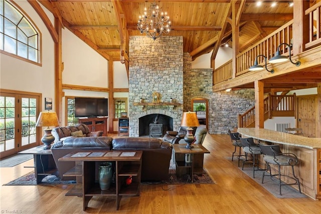 7239 Bulb Rd, Julian, NC 27283 - living area with a wood ceiling with exposed beams, high vaulted ceiling, stairway, healthy amount of natural light, and a fireplace