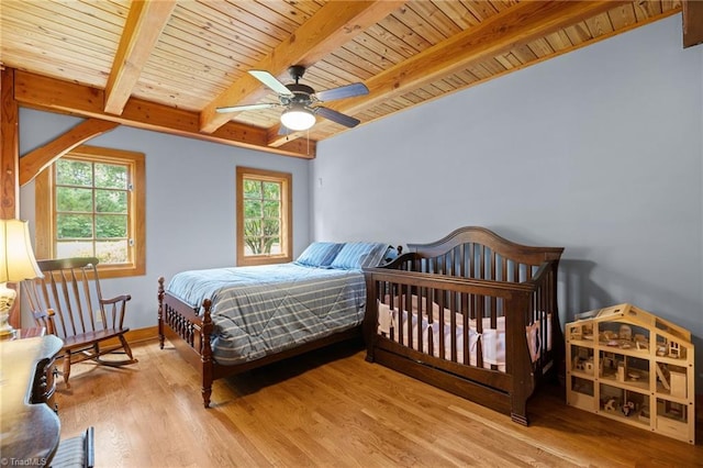 7239 Bulb Rd, Julian, NC 27283 - bedroom with a wood ceiling with exposed beams, multiple windows, wood finished floors, and a ceiling fan