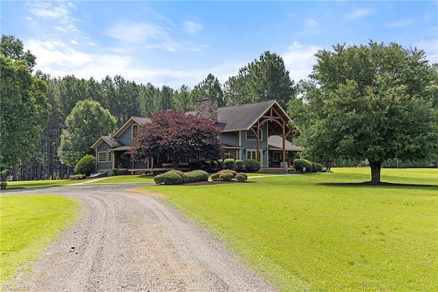 7239 Bulb Rd, Julian, NC 27283 - obstructed view of property with a front yard, curved driveway, and a chimney