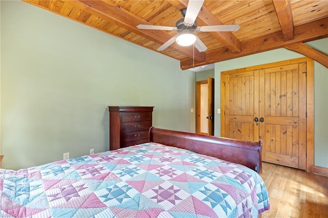 7239 Bulb Rd, Julian, NC 27283 - bedroom with a wood ceiling with exposed beams, wood finished floors, a ceiling fan, and a closet