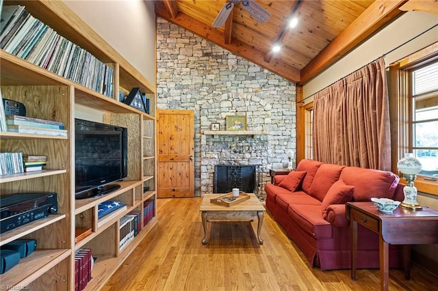 7239 Bulb Rd, Julian, NC 27283 - living area with a stone fireplace, wood finished floors, a wood ceiling with exposed beams, high vaulted ceiling, and ceiling fan