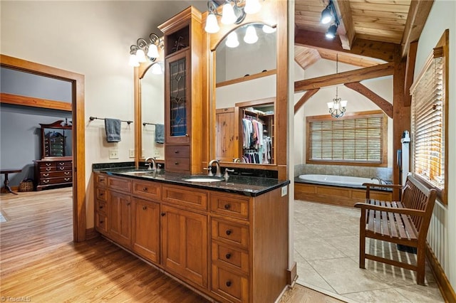 7239 Bulb Rd, Julian, NC 27283 - full bathroom featuring a chandelier, double vanity, a garden tub, and wooden ceiling