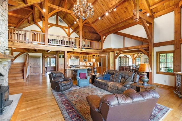 7239 Bulb Rd, Julian, NC 27283 - living room with a chandelier, high vaulted ceiling, plenty of natural light, a wooden ceiling with exposed beams, and stairs