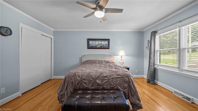 1926 Downing Dr, Burlington, NC 27215 - bedroom featuring wood finished floors, ornamental molding, ceiling fan, and a closet