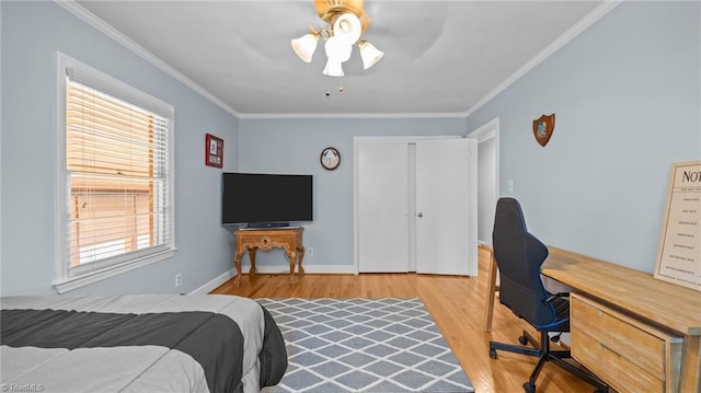 1926 Downing Dr, Burlington, NC 27215 - bedroom with wood finished floors, ornamental molding, multiple windows, a desk, and a closet
