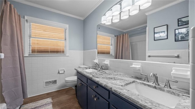 1926 Downing Dr, Burlington, NC 27215 - bathroom with tile walls, wood finished floors, double vanity, crown molding, and a shower with shower curtain