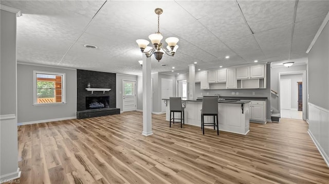 1926 Downing Dr, Burlington, NC 27215 - kitchen featuring open floor plan, dark countertops, white cabinetry, light wood-style flooring, and recessed lighting