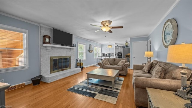 1926 Downing Dr, Burlington, NC 27215 - living area with ceiling fan, ornamental molding, a brick fireplace, and wood finished floors