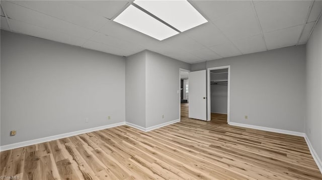 1926 Downing Dr, Burlington, NC 27215 - unfurnished bedroom with a drop ceiling, light wood-style floors, and a closet