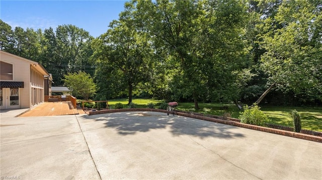 1926 Downing Dr, Burlington, NC 27215 - view of patio / terrace with a wooden deck, view of wooded area, and french doors