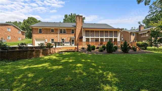 1926 Downing Dr, Burlington, NC 27215 - rear view of house featuring a deck, a chimney, a sunroom, a garage, and brick siding