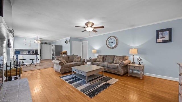 1926 Downing Dr, Burlington, NC 27215 - living area with a ceiling fan, ornamental molding, wood finished floors, and a chandelier