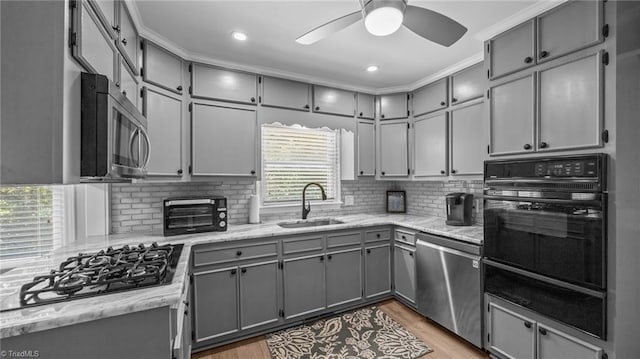 1926 Downing Dr, Burlington, NC 27215 - kitchen with black appliances, gray cabinetry, a warming drawer, ceiling fan, and backsplash
