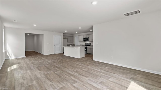 6598 Capstone Ct, Rural Hall, NC 27045 - unfurnished living room featuring recessed lighting, baseboards, and light wood-type flooring