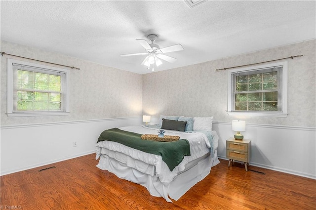 3228 Valley Rd, Winston-Salem, NC 27106 - bedroom with wood finished floors, a textured ceiling, and ceiling fan