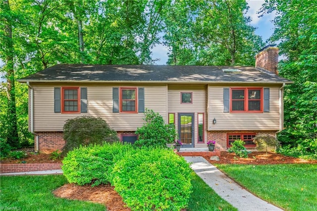 3228 Valley Rd, Winston-Salem, NC 27106 - bi-level home featuring a chimney, a front yard, and brick siding