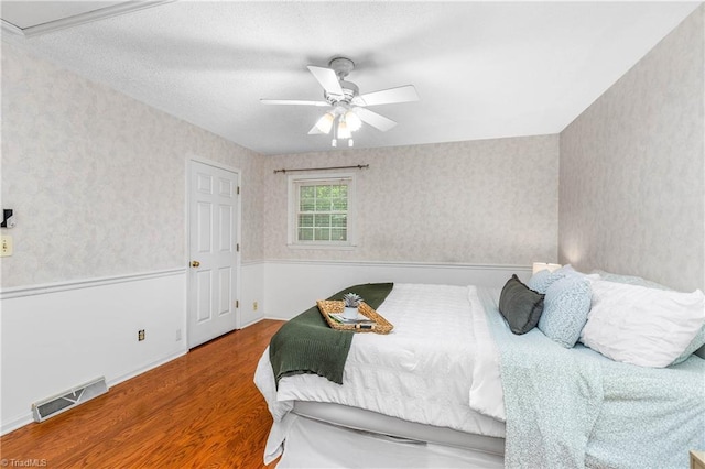 3228 Valley Rd, Winston-Salem, NC 27106 - bedroom featuring wood finished floors, wallpapered walls, and ceiling fan