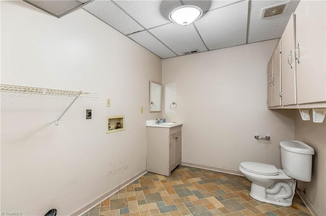 3228 Valley Rd, Winston-Salem, NC 27106 - bathroom featuring a drop ceiling, vanity, and stone finish floors
