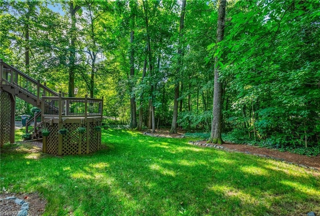3228 Valley Rd, Winston-Salem, NC 27106 - view of green lawn with stairway, a wooden deck, and a view of trees